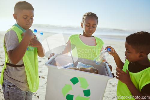 Image of Group of children cleaning beach or recycling plastic for education, learning or community help in climate change project, ngo and charity. African friends with recycle box and teamwork on earth day