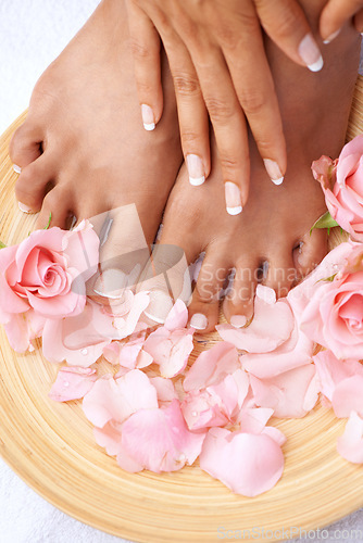 Image of Beauty treatment, skincare and feet of a woman with flowers for cleaning, pedicure and detox. Spa, dermatology and foot and hands of a model with a floral, cosmetic and natural manicure with roses