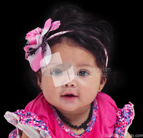 Image of Portrait, baby or girl with an innocent infant in studio on a black background in floral clothes. Kids, flower and development with a female child on dark space for cute or adorable product placement