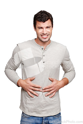 Image of Hungry, sick and portrait of a man with a stomach problem isolated on a white background in studio. Stress, pain and person with a stomachache, abdominal pain or painful ibs on a studio background