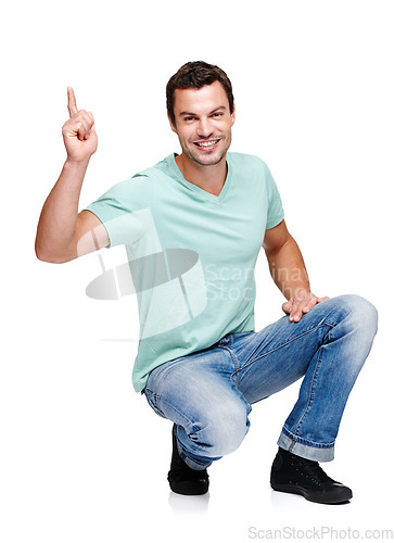Image of Portrait, mock up and pointing with a man in studio isolated on a white background for marketing or advertising. Product, branding and mockup with a handsome young male posing to promote a brand