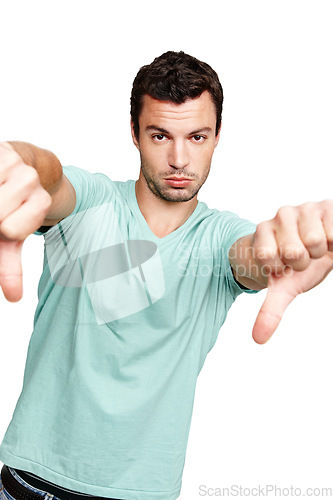 Image of Man, hands and thumbs down standing in disappointment for fail, wrong or disagree against white studio background. Portrait of isolated young male casual model pointing thumb down on white background