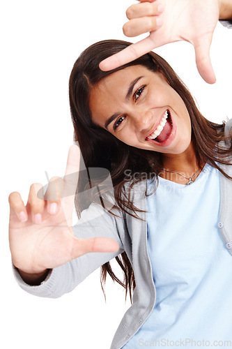 Image of Woman face, portrait and hands framing of a model smile with happiness and white background. Isolated, young person and hand frame of a happy female laughing and having fun in a studio alone