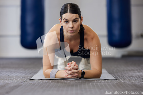 Image of Fitness, woman and plank exercise in gym for wellness training, healthy lifestyle and workout. Portrait, focus and strong female athlete on elbow, floor and push up for sports, body muscle and power