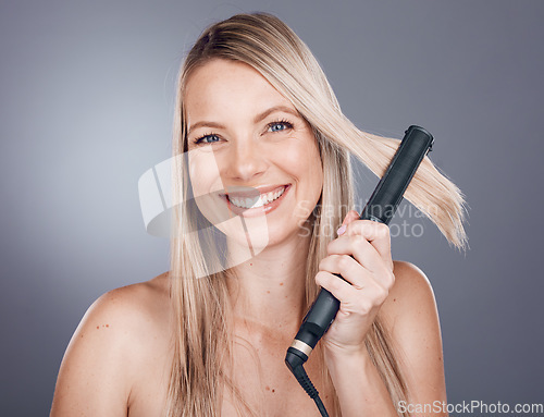 Image of Woman, hair care portrait and flat iron with smile, beauty and happiness with self love by studio background. Model, hair and self care grooming with straightener for hairstyle aesthetic by backdrop