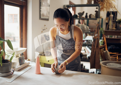 Image of Design, sculpt and pottery business woman with clay for creativity, inspiration and art process in workshop. Creative, small business and asian girl working at artistic workspace in Tokyo, Japan