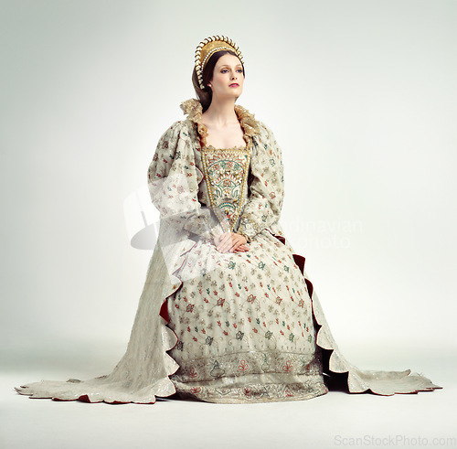 Image of Queen, crown and vintage with a woman in studio on a gray background as ruler of the monarch during the renaissance period. History, royalty and victorian with an elegant female posing as a leader