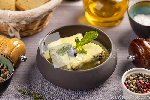 Image of Poppy seeds cake topped with vanilla sauce