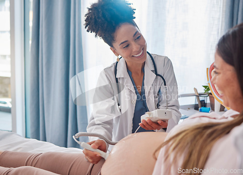 Image of Woman, pregnancy and doctor, ultrasound at clinic with happiness, excited and family planning for future. Black woman medic, pregnant woman and consulting with medical tech on stomach for sonogram