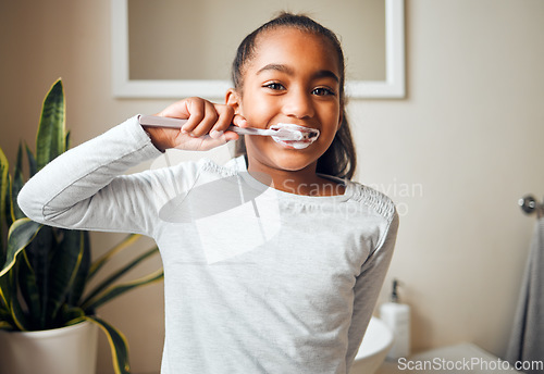 Image of Girl brushing teeth, portrait and toothbrush for hygiene with clean mouth and fresh breath with dental health. Kid, cleaning with toothpaste in bathroom and wellness at family home with healthy gums