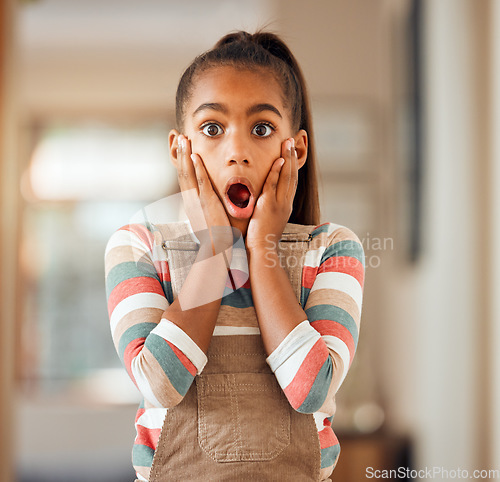 Image of Little girl, hands and face in shock, surprise or wow for deal, discount or sale standing with expression at home. Portrait of female child, kid or toddler surprised or shocked for news at the house