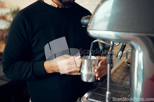 Image of Hands, man and barista brewing coffee at cafe using machine for hot beverage, caffeine or steam. Hand of employee male steaming milk in metal jug for premium grade drink or self service at shop