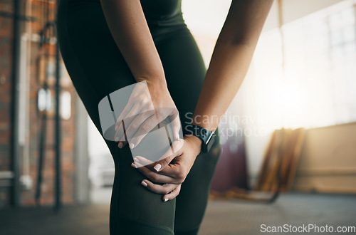 Image of Knee injury, woman and fitness accident, pain and medical emergency, muscle strain from exercise in gym. Workout, health and wellness, athlete hands with inflammation and injured leg from training