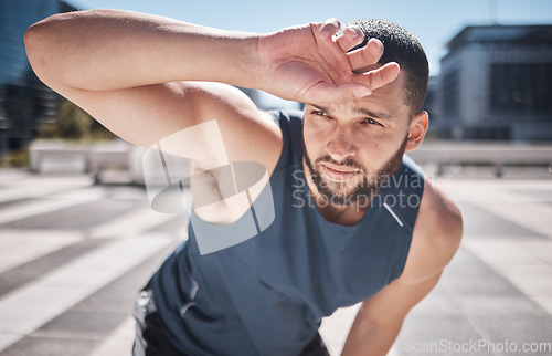 Image of Fitness, man and relaxing on break from workout, training or exercise in the city for healthy recovery in the outdoors. Sporty male breathing feeling tired, exhausted or drained after running cardio
