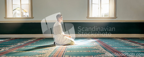 Image of Mosque, worship and muslim man in prayer on his knees for gratitude, support or ramadan for spiritual wellness. Religion, tradition and islamic guy praying or reciting quran to allah at islam temple.