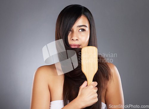 Image of Woman, brush and hair care for beauty, wellness and self care by studio background with natural shine. Model, hair and self love with organic wooden hairbrush for sustainable cosmetics by backdrop