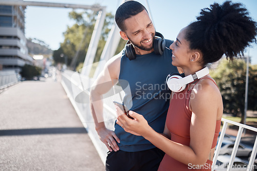 Image of Fitness, exercise and black couple with phone in city for running, marathon training and workout on bridge. Love, sports and man and woman on smartphone for social media, music and health mobile app