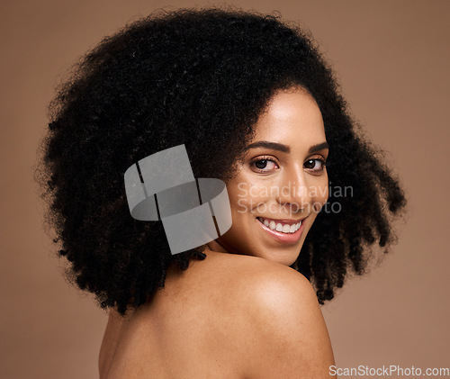 Image of Black woman, studio portrait and beauty with smile, cosmetic glow and healthy with afro by backdrop. Model, skincare and natural hair care for aesthetic, wellness and self care by brown background