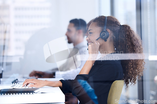 Image of Call center, customer service and glass with a black woman consultant working in her telemarketing office. Contact us, crm and communication with a female consulting at work using a headset