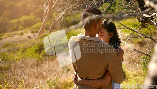 Image of Nature, love and a couple hugging or kissing outdoor while sharing an intimate moment together in summer. Field, countryside and kiss with a man and woman bonding in sweet embrace outside with mockup