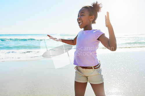 Image of Kids, beach and dance with a black girl having fun alone on the sand in summer by the sea or ocean. Nature, Children and blue sky with a female child dancing by the water while on holiday or vacation