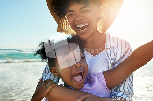 Image of Family, children and beach with a mother and daughter laughing or joking together in the ocean or sea. Love, kids and coast with a black woman and girl having fun while bonding by the water in nature