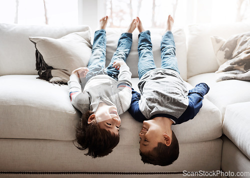 Image of Children upside down, playing and happy at family home for fun with sibling, brothers on sofa and relax in living room. Happy people, love and quality time together, playful kid boys with laughing