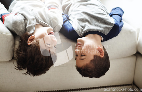 Image of Children upside down, play and happy at family home, fun with sibling and face of brothers on sofa and relax in living room. Happy people, love and quality time together, playful kid boys and funny