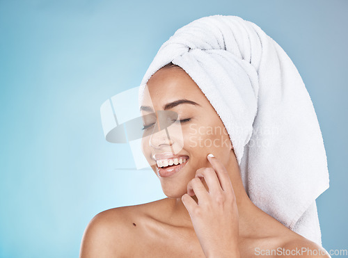 Image of Woman, face and happy skincare with towel for luxury beauty, salon spa cleaning and closed eyes in blue background studio. Happy model, smile and skin glow, facial wellness or hair care dermatology