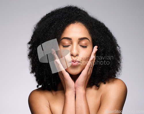 Image of Face kiss, beauty skincare and black woman with eyes closed in studio isolated on a gray background. Makeup, natural cosmetics and young female model pouting lips satisfied with spa facial treatment.