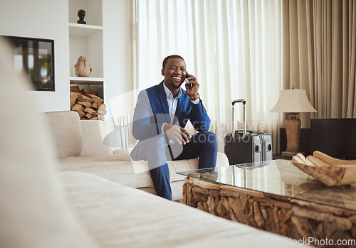 Image of Happy businessman in hotel, on smartphone call and business communication for work in Atlanta. Young black entrepreneur, listening to audio on cellphone and sitting on luxury sofa in living room