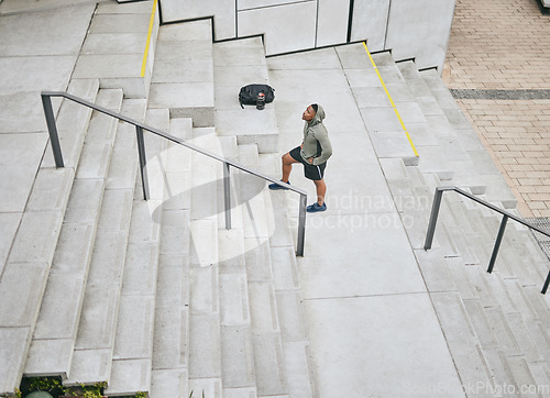 Image of Fitness, tired or black man walking on stairs for training, exercise or cardio workout in Chicago, USA. Mission, mindset or healthy athlete in hoodie thinking of sports goals or breathing on steps