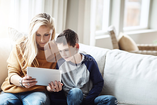 Image of Tablet, love and mother with boy on sofa bonding, quality time and relax on weekend together. Family home, lifestyle and mom and kid with digital tech for online games, social media and internet app