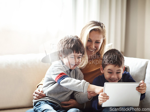 Image of Family, tablet and mother with children on sofa bonding, quality time and relax on weekend together. Love, family home and mom and kids with digital tech for online games, learning and internet app
