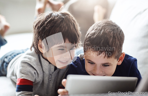 Image of Happy children, bonding or tablet on relax house sofa in home living room on brothers esports, social media or movies. Smile, fun or kids streaming on digital technology in team education or learning