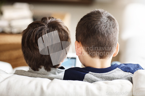 Image of Kids, bonding or tablet for movies streaming, esports or social media on relax house sofa or home living room. Brothers, curious or children on digital technology in education learning or team gaming