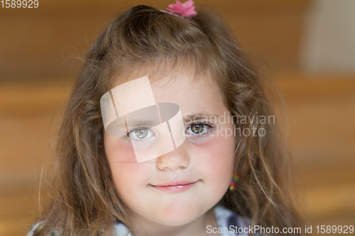 Image of happy cute little girl with curly golden hair