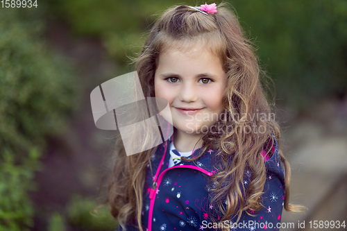 Image of happy cute little girl with curly golden hair