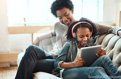 Image of Black family, headphones and tablet to listen to music, streaming and online learning on lounge sofa. Woman or mother and teenager together in living room while happy about home wifi for education