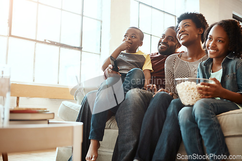 Image of Happy black family on sofa for movie, television or film together, bonding and quality time in living room. Popcorn, kids TV show and people, mother and father with kids, sitting on couch watching