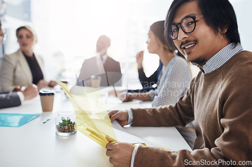 Image of Portrait, business and Asian man in meeting, conversation and corporate success in modern office, planning and strategy. Male employee, financial adviser or team talking, budget and accounting folder