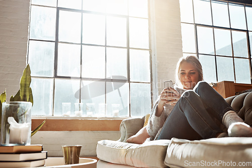 Image of Woman with smartphone, social media and relax, communication and technology while chilling on sofa at home. Phone, typing online and connectivity, chat on mobile app with wifi in apartment