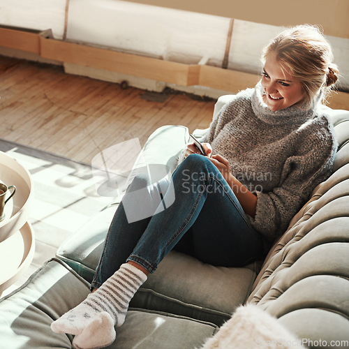 Image of Phone, house couch and happy woman on the web in a living room calm on a social media scroll. Home sofa, lounge and person relax on a mobile online on wifi with a smile from streaming content