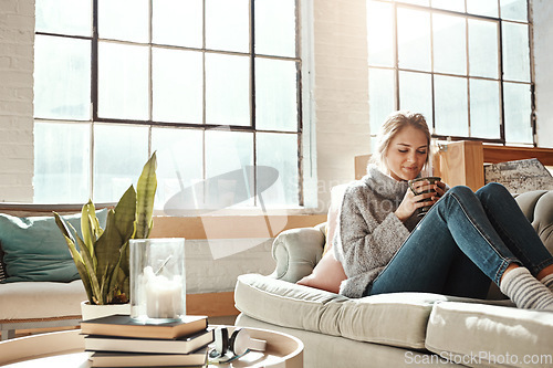 Image of Woman relax in living room, coffee and peace on sofa, content at home with lifestyle and happiness. Female in apartment, happy woman and coffee cup, positive energy and mindset with wellness