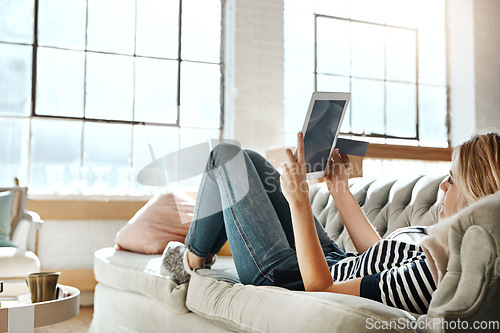 Image of Woman, tablet and credit card for online shopping on sofa relaxing in the living room for ecommerce at home. Female shopper banking on touchscreen with bank card for purchase, app or sale on couch