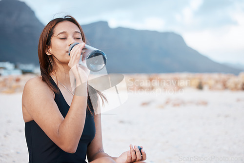 Image of Beach, health and woman drinking water swimming in the sea while on summer vacation in Hawaii. Wellness, ocean and girl enjoying refreshing drink while relaxing on seaside holiday, trip or adventure.