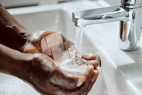 Image of Black man, house bathroom or washing hands with water for healthcare wellness, hygiene maintenance or home self care. Zoom, wet or sink tap for cleaning, skincare grooming or bacteria safety routine