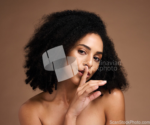 Image of Black woman, portrait and finger on lips for secret to skincare, cosmetics and body wellness on studio background. Face of female model with silence gesture on mouth for beauty, quiet and shush hands