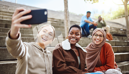 Image of Women, diversity or phone selfie on university stairs, school steps or college campus bleachers for social media or profile picture. Smile, happy or bonding students on mobile photography technology