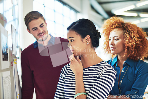 Image of Business people, board and thinking in office with focus, learning or strategy for teamwork success. Group diversity, women and businessman reading whiteboard for marketing, team building or planning